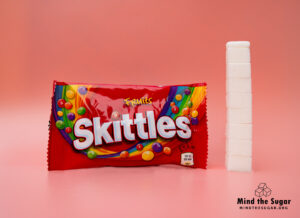 A photo of Skittles Fruit bag with 8.3 cubes of sugar.